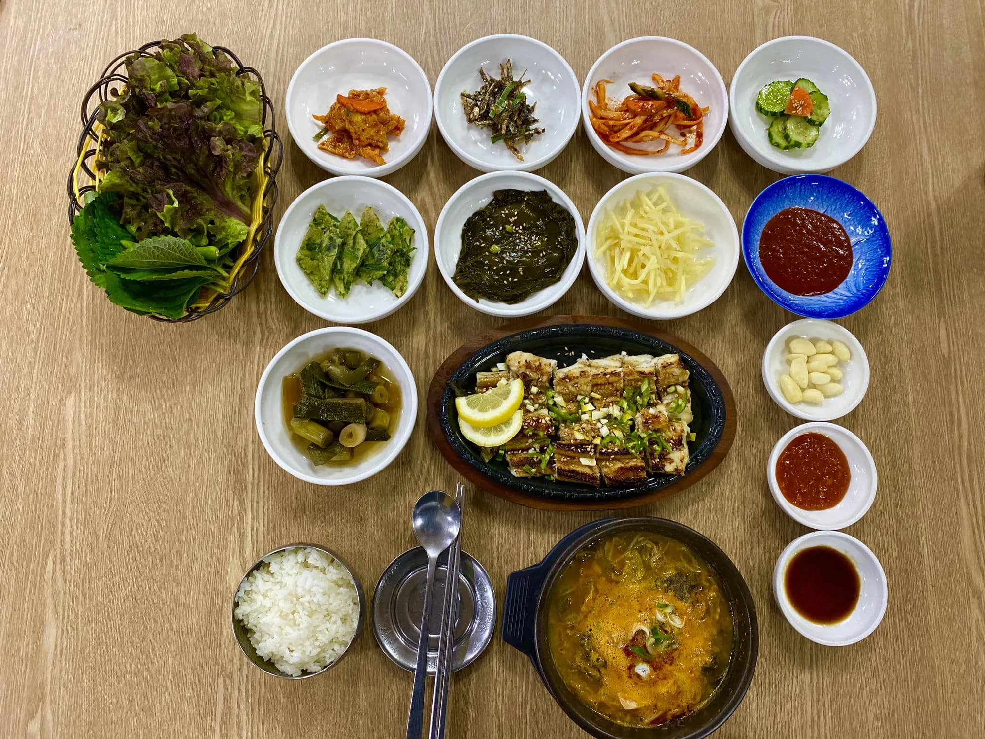 장어정식 한 상: 쌈채소 바구니, 열 가지 반찬, 철판 장어구이, 장어탕과 공깃밥